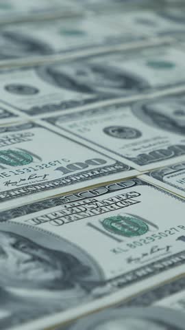 American money paper one hundred dollars banknotes. 100 dollar bills loop. Sheet of US dollar bills. Printing dollar banknotes. Cash money background. Vertical video