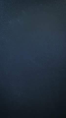 Man writing word hello on chalkboard. Hello word written on blackboard with white chalk. Vertical video