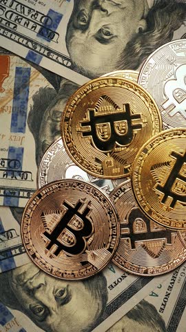 BTC. Bitcoin cryptocurrency. Gold and silver coins rotating on dollars banknotes. Vertical video. Online investments. Exchange stock market. Virtual money. Bitcoin mining. Trading market