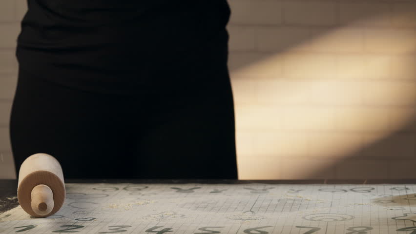Patissier Dusting The Counter With Flour To Rollout The Dough - Closeup Shot