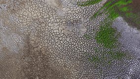 Dry and cracked gray soil ground during drought, viewed from above. top view. earthquake cracking holes, cracked wall, ground cracks top view, ruined land surface crushed texture. destruction - Powered by Shutterstock - Get 15% off with code: PIKWIZARD15