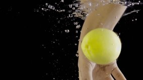 Human hand grabbing lemons, floating under water against black background. - Powered by Shutterstock - Get 15% off with code: PIKWIZARD15