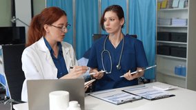 Doctor team, working on desk with laptop computer and paperwork in the office. - Powered by Shutterstock - Get 15% off with code: PIKWIZARD15