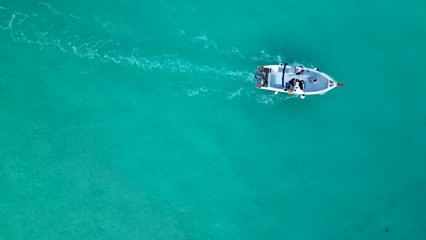 Top Down Drone Video of a Boat Sailing in the Blue Lagoon on Comino Island, Malta