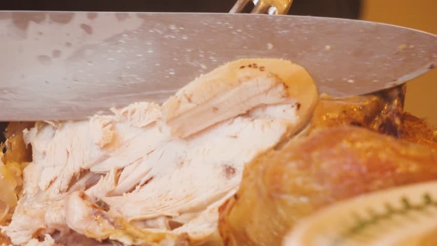 Roasted Whole Chicken Being Carved at Dinner Table with Sharp Knife and Served on Plate. Poultry High Protein Meal Being Served to Family and Guests 4K.