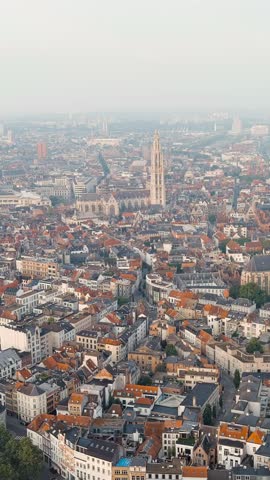 Vertical video. Antwerp, Belgium. Panorama overlooking the Cathedral of Our Lady (Antwerp). Historical center of Antwerp. City is located on the river Scheldt (Escaut). Summer morning, Aerial View