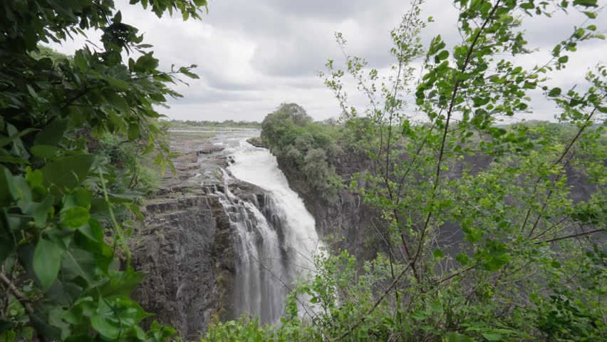 The Victory Falls natural wonder of the world from the Zimbabwean viewpoint with greenery in the foreground during the rainy season