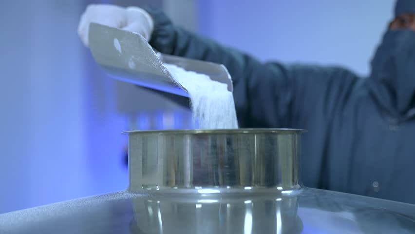 powder medicine mixing and blending process close up. dusting powder chemical pharma ingredient in a large equipment production line in a pharma manufacturing plant factory	
