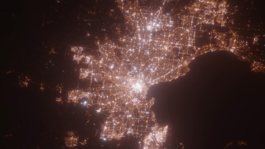 Melbourne (Australia) top view at night. Aerial view on modern city with lights. Camera is flying above the city, moving backward. Vertical video. The north is on the left side