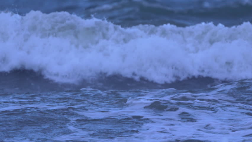 Intense ocean wave crashes with foamy white crest, vibrant and powerful.