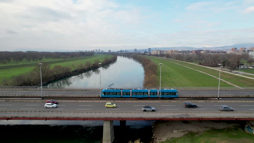 Closeup 4K aerial view of the famous Bridge of Youth (Most Mladosti) over the river Sava in Zagreb, the capital city of Croatia, with the trams and vehicles driving over it.
