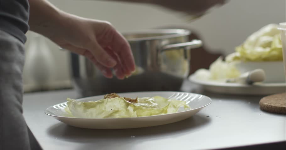 Stuffing cabbage leaf with a meat 4K footage