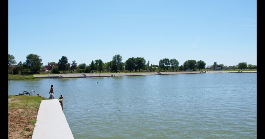 Serenity at the lake under clear blue skies, a perfect day for relaxation and nature observation