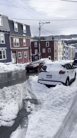 St John’s Newfoundland downtown jelly bean Road colourful houses in winter with snow on ocean front 