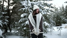 Happy young smiling woman walking and enjoying by winter forest among snow covered pine trees. - Powered by Shutterstock - Get 15% off with code: PIKWIZARD15