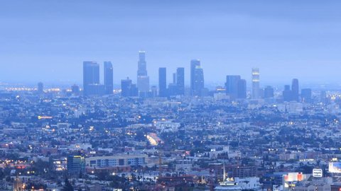 Los Angeles city timelapse. Transition from dusk to night. View from Hollywood Hills on freeway 101, zoom-out from downtown LA.