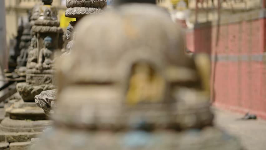 Buddha Statue at Buddhist Temple in Kathmandu Nepal, Close Up Detail and Reveal of Buddhist Stone Statues at a Famous Religious Site for Buddhism Religion