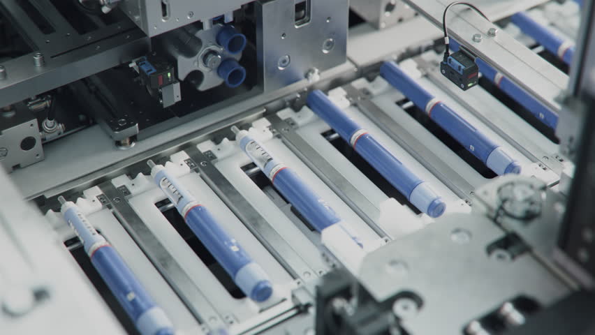 Medicinal Drug Production Plant. Row of Insulin Injection Pens on Conveyor Line during Production Process at Modern Pharmaceutical Factory. Weight Loss Medication Manufacturing.