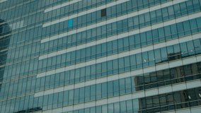 Contemporary high-rise office building with reflective glass facade, showcasing geometric design and urban architecture in Bangkok, Thailand. - Powered by Shutterstock - Get 15% off with code: PIKWIZARD15