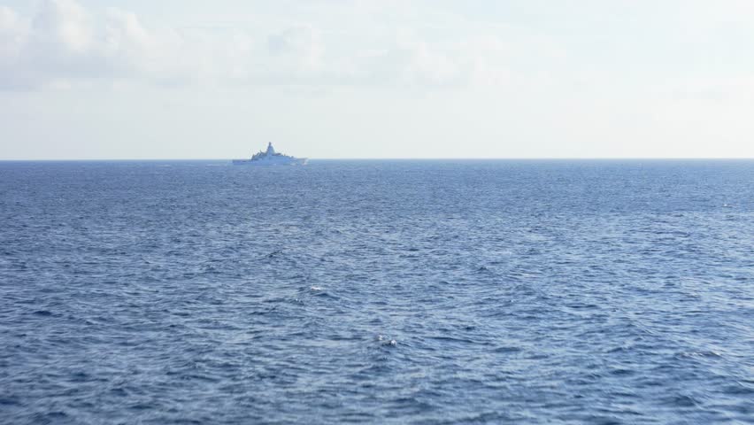 Drone orbit of an offshore patrol vessel, cruising in the open sea, highlighting naval operations