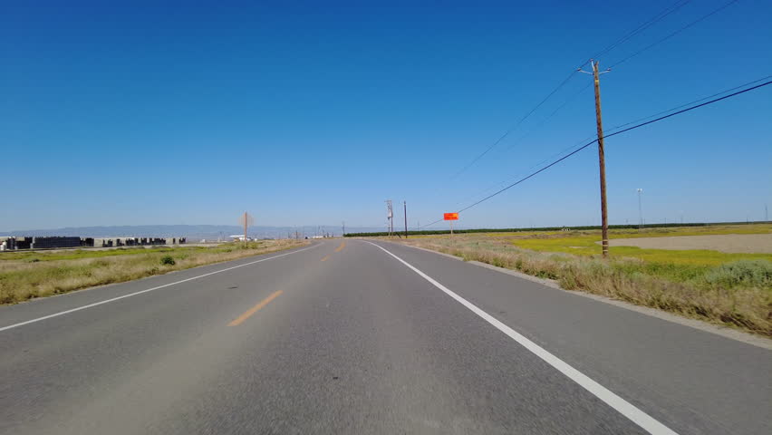 San Joaquin Valley Farmland Buttonwillow 01 Front View Driving Plates of Highway 58 West California USA