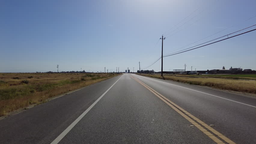 San Joaquin Valley Farmland Buttonwillow 02 Rear View Driving Plates of Highway 58 West California USA