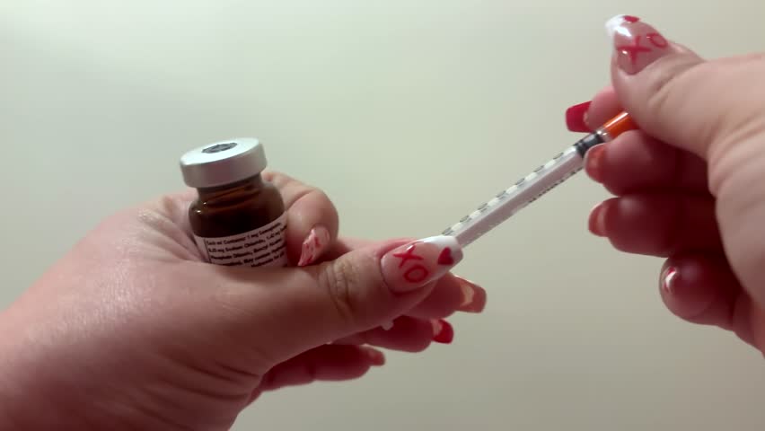 Woman preparing dosage of Ozempic or Wegovy injection with syringe for either weight loss or diabetes shot