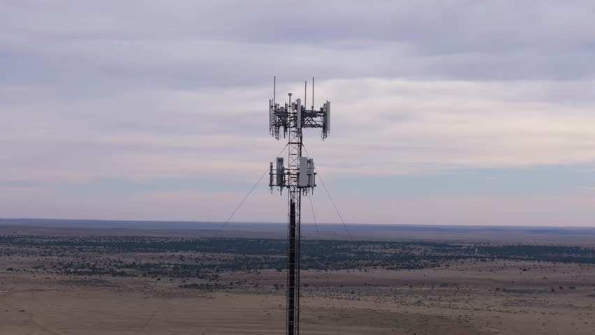 Tall communication tower standing alone in the vast, open Texas desert landscape