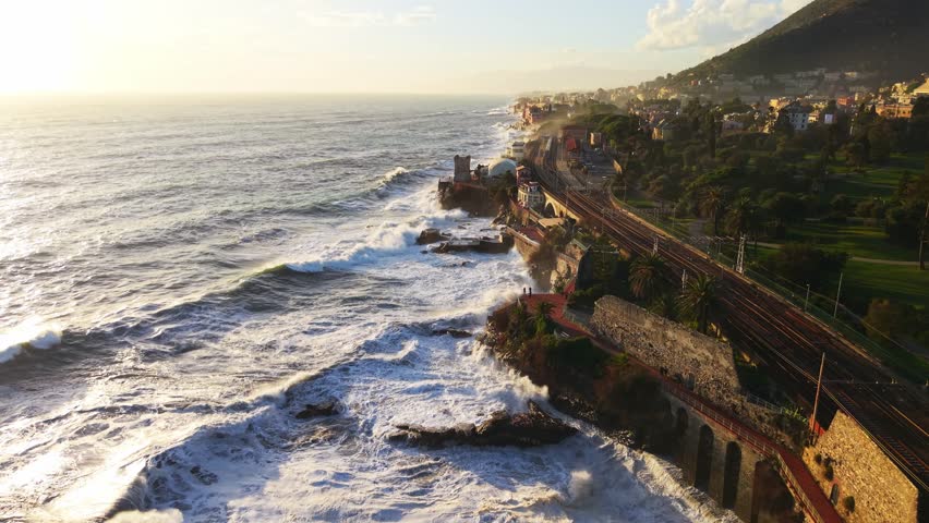 Big waves crashing against the coastal line of Liguria, Italy at sunset