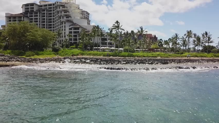Beautiful 4K aerial drone footage showcasing the luxurious Four Seasons Resort in Oahu, Hawaii. This stunning flyover captures the resort’s beachfront, lush tropical landscaping, and ocean waters.