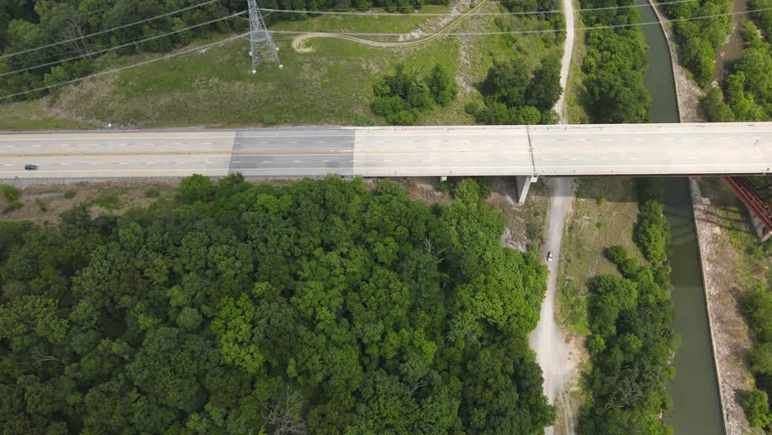 Cars passing over a bridge that passes over the shenandoah River in West Virginia.
