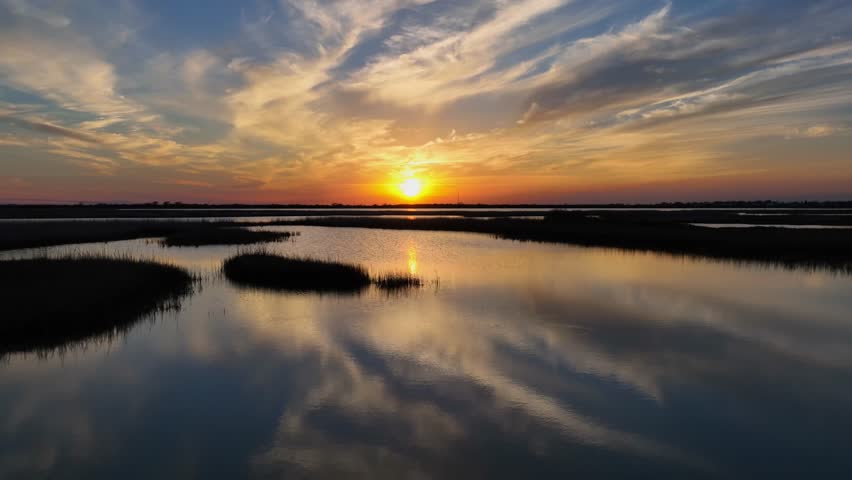 Sunset over marsh, wetlands on the gulf coast of southern Texas. Drone dolly forward UHD