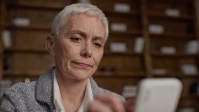 Senior woman skeptical while online shopping on smartphone - Powered by Shutterstock - Get 15% off with code: PIKWIZARD15