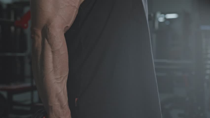 A Man Working Out Using Dumbbell