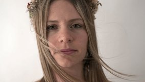 The camera captures a close-up of the bride's face, her floral crown adds to her elegance. She looks away, her expression serene, creating a moment of quiet beauty. - Powered by Shutterstock - Get 15% off with code: PIKWIZARD15