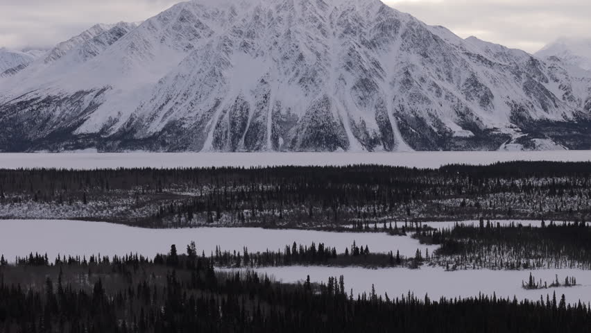 Snow-Covered Mountains During Winter In Kathleen Lake, Yukon, Canada. Aerial Wide Shot