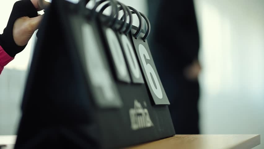 Competitive game scoreboard display showing current points and rankings during an exciting match in a sports arena