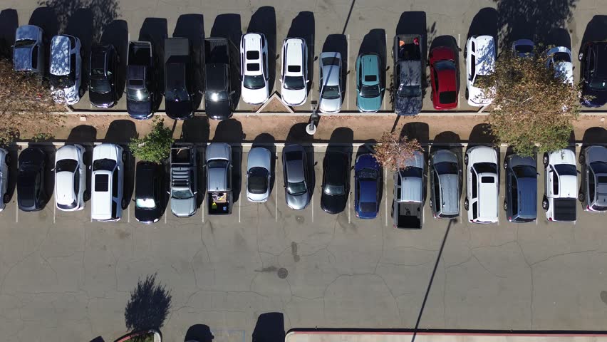 Drone Video above parking lot full of cars at local public park