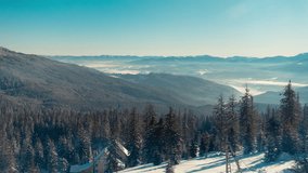 Winter Landscape in Mountains. Fog Flows Through The Valley, Smoke Comes From the Chimney of a Log Cabin, Melting Snow Falls From the Fir Trees and Crows Sit on the Trees. Time Lapse in Dragobrat - Powered by Shutterstock - Get 15% off with code: PIKWIZARD15