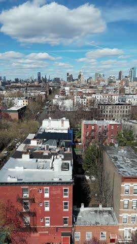 vertical Drone side-tracking left shot over Clinton Street, Brooklyn, featuring buildings, streets, and the urban landscape during the day.