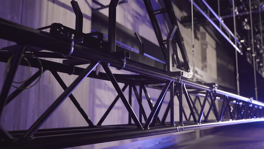 A Large Theater Truss is Slowly Lifted up with Several Sturdy Metal Cables. Lighting or Stage Truss Allows Lighting Designers the Freedom to Hang LED or Automated Fixtures, Where Ever they Choose.