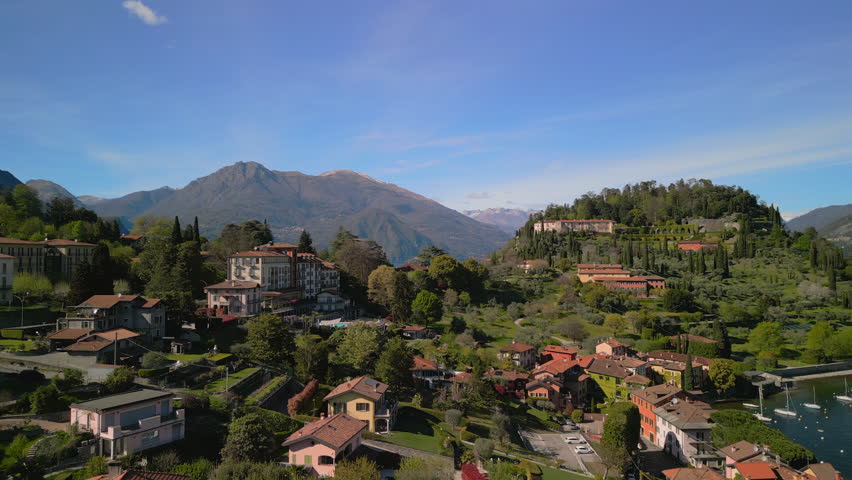 Experience the stunning aerial view of Lake Como, showcasing its vibrant landscapes, charming villages, and majestic mountains in the heart of Italy during the beautiful sunny season