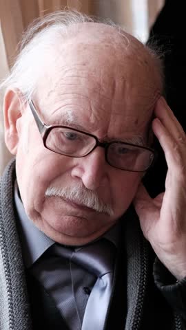 A self-absorbed and contemplative elderly man, depicted in a pensive pose and manner