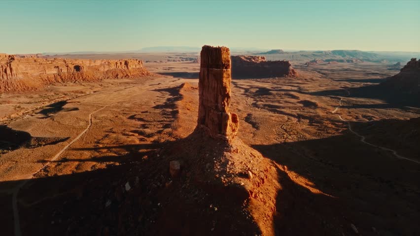 4K Aerial drone footage circling around massive butte rock formation in Valley of the Gods Monument Valley, Utah. Epic vistas all around of multiple formations, buttes, and mesas