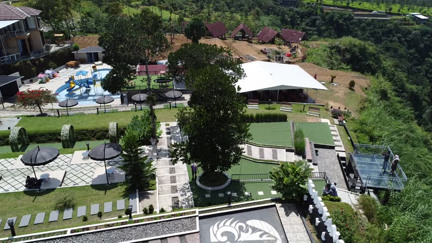 The view of the park is taken from a height. Below the park there is a lake