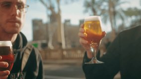 Young men having fun together,celebrating and cheers drinking beer and clinking glasses outdoorclose-up. - Powered by Shutterstock - Get 15% off with code: PIKWIZARD15