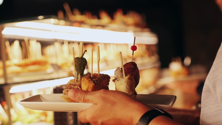 Italian or Spanish restaurant with traditional tapas pinchos food, Spanish cuisine, delicious tapas and cheese plate, bruschetta with cheese, olives dry tomatoes tasty sandwich bar appetizer, buffet