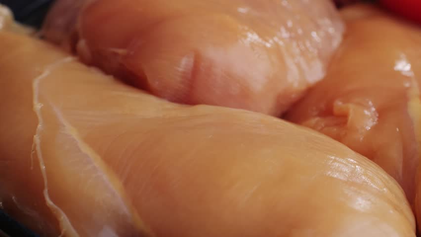 Raw chicken meat on plate close-up. Preparing raw food for cooking. Grilled chicken, duck, turkey kebab with vegetables.