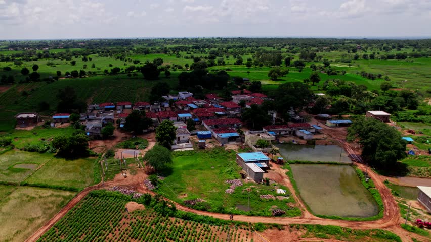 Clouds Shadow completely covered village with trees and water at tekmal village, Medak district, telangana, india. day time, semi orbit, drone shot, 4k.