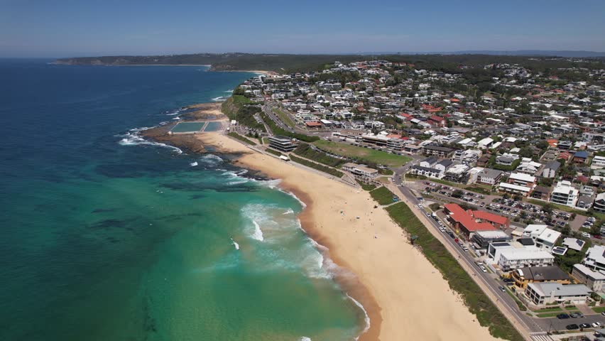 Merewether Beach With Ocean Baths On Shoreline Of New South Wales In Australia. aerial descend